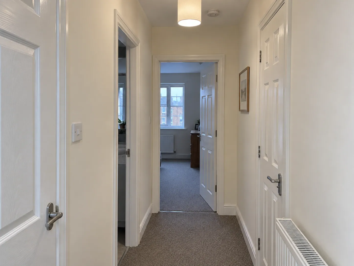 AI-generated illustration: Neutral painted hallway with white doors and trim