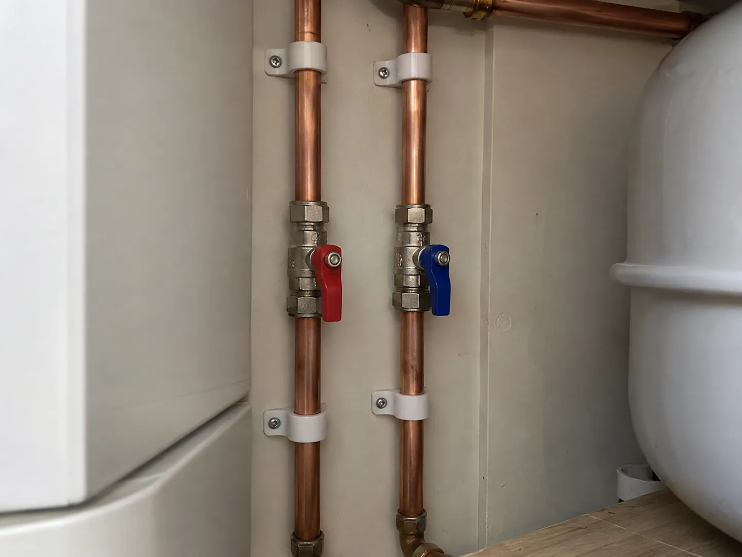 AI-generated illustration: Accessible isolation valves on copper pipework